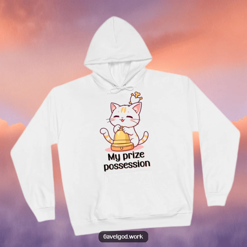 Funny Kawaii cat playfully batting at an auction bell, a soft and humorous hoodie for cozy cat lovers.